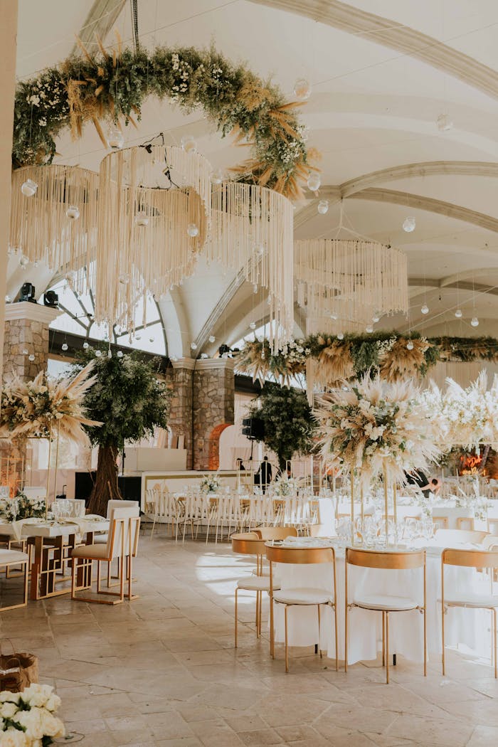 Beautifully decorated wedding hall with chandeliers and floral arrangements, perfect for ceremonies.